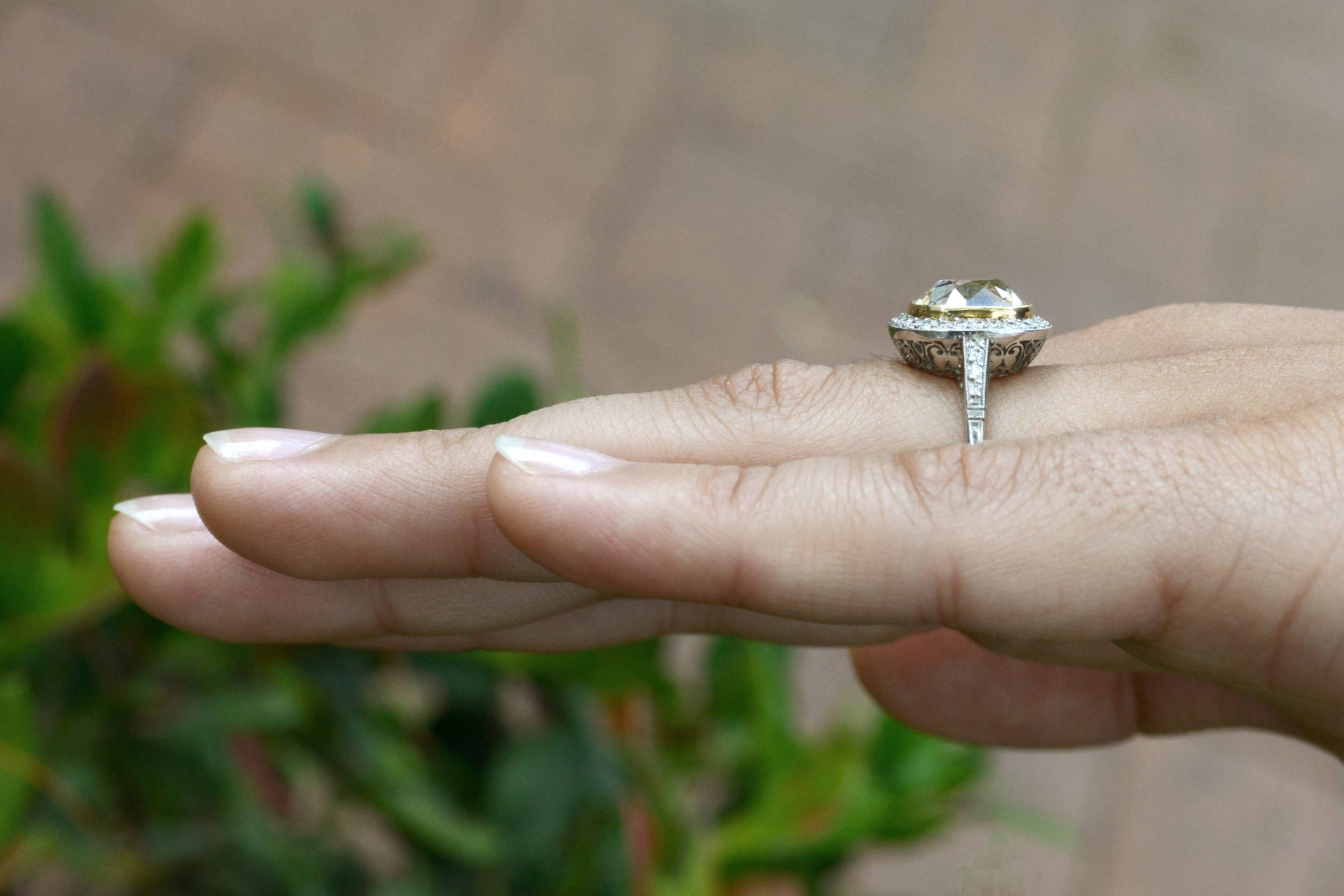 A big, 5 carat bezel-set, cushion diamond wedding ring.
