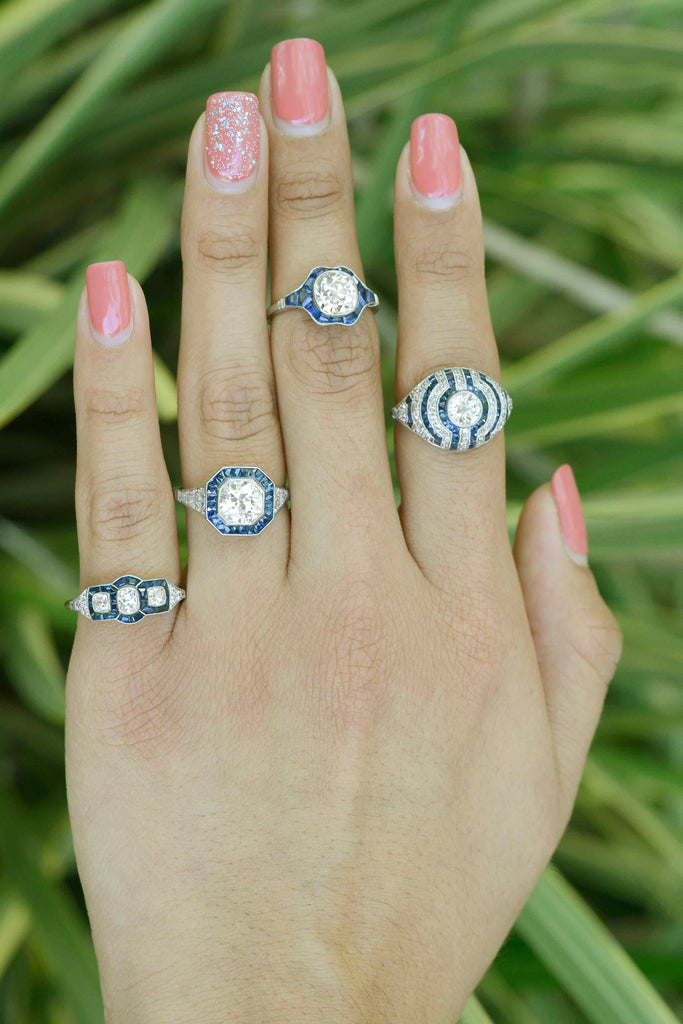 Art Deco style engagment rings with diamonds and blue sapphires.