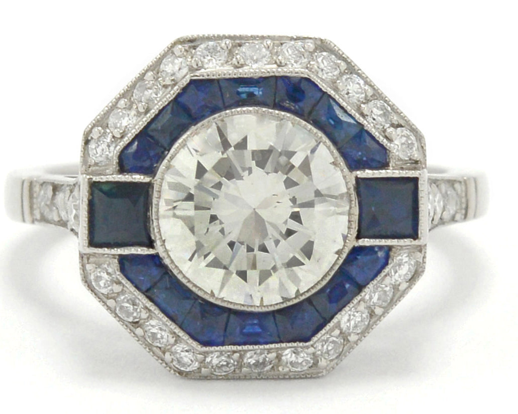A round diamond with French and calibre cut sapphires engagement ring.