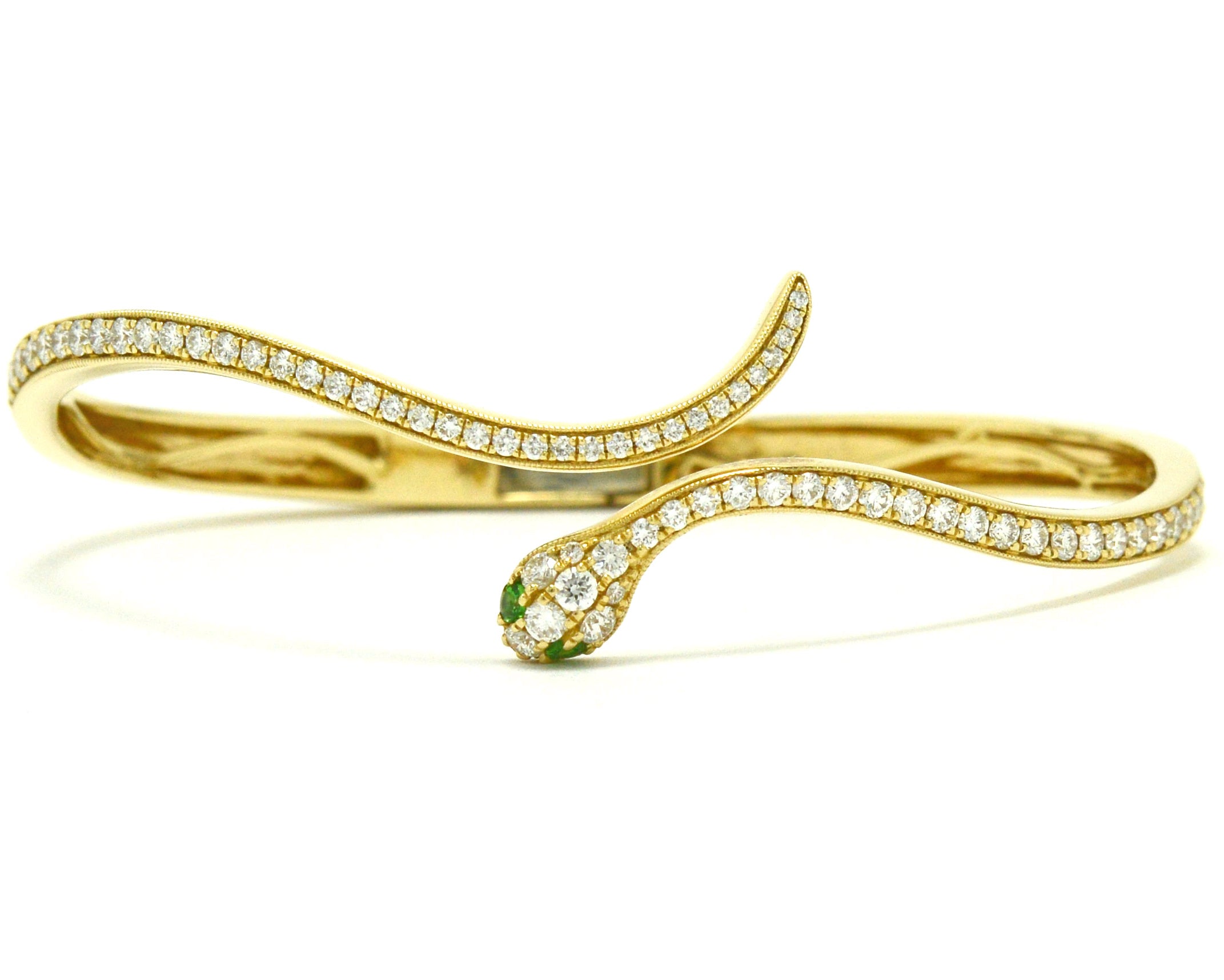 A newly made 14k Egyptian revival snake bangle bracelet with diamonds.