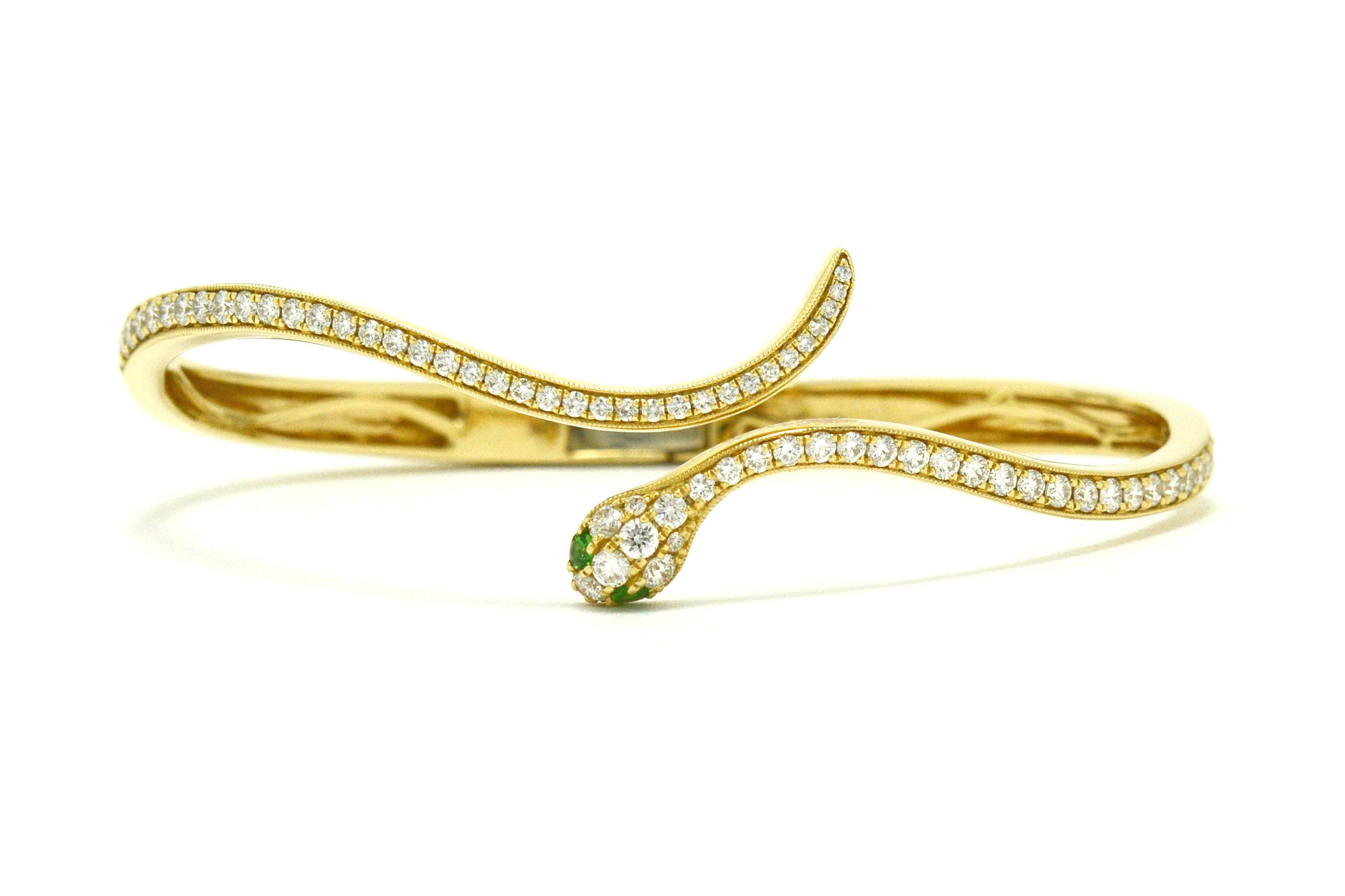 A newly made 14k Egyptian revival snake bangle bracelet with diamonds.