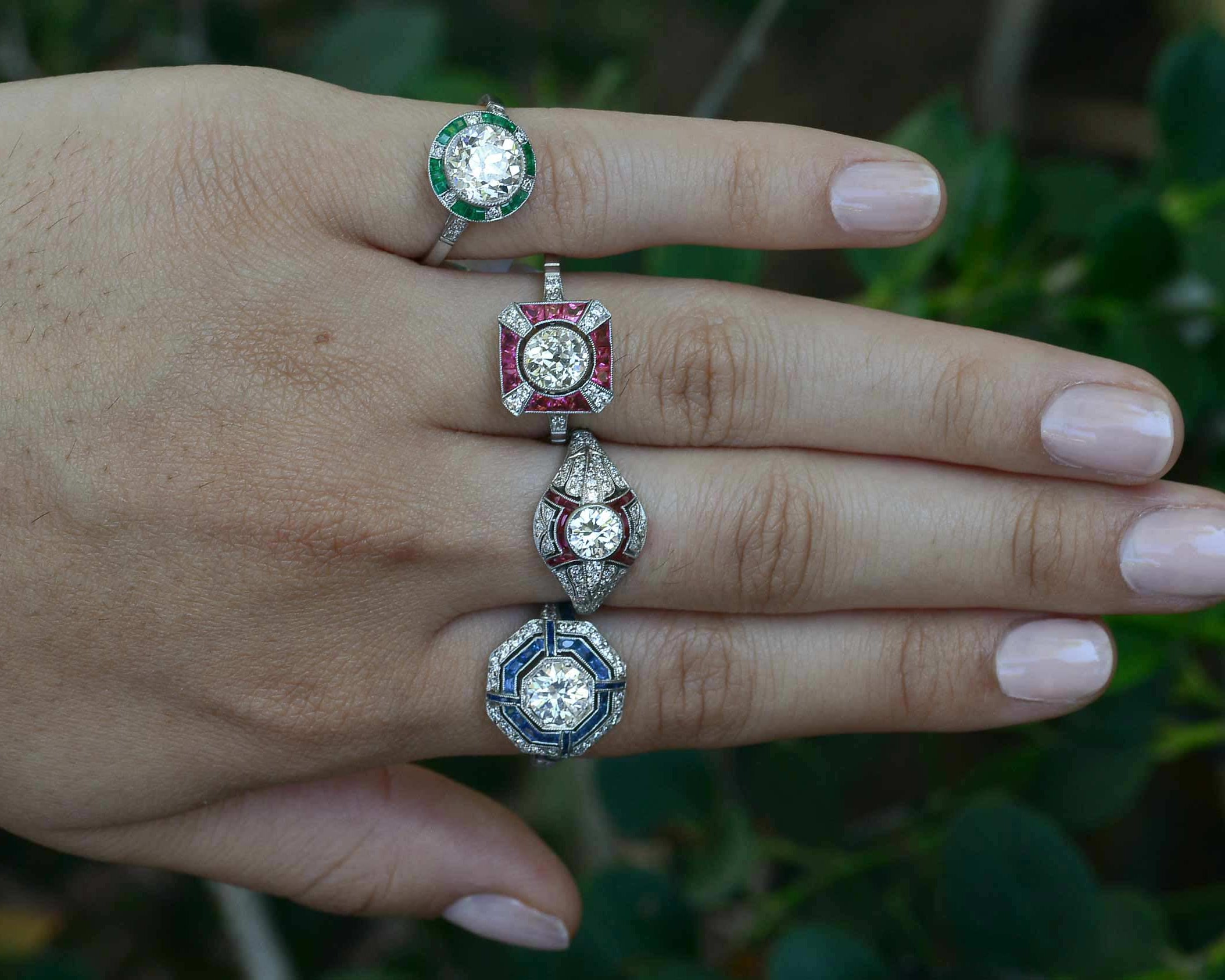 Art Deco style diamond and gem halo engagemnt rings.
