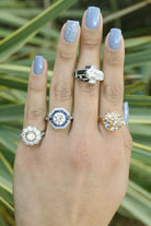 A collection of diamond cluster engagement rings.