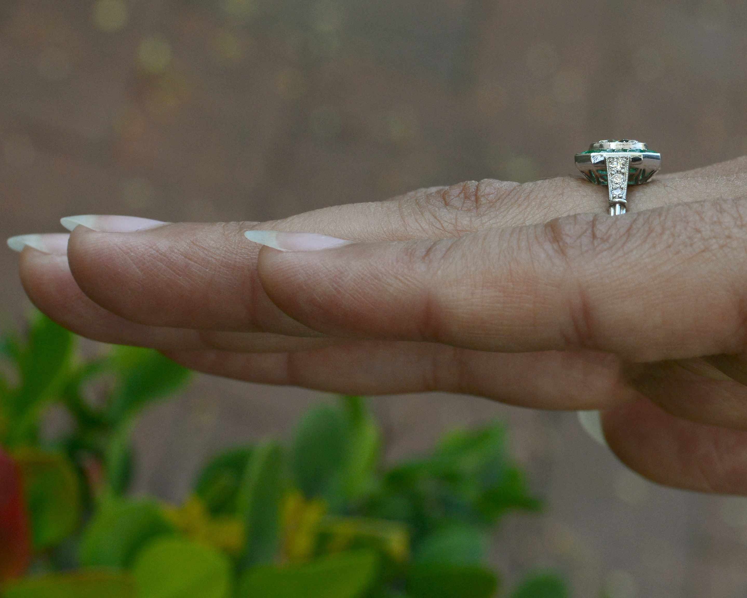 A diamond emerald wedding ring with diamonds on the shank.