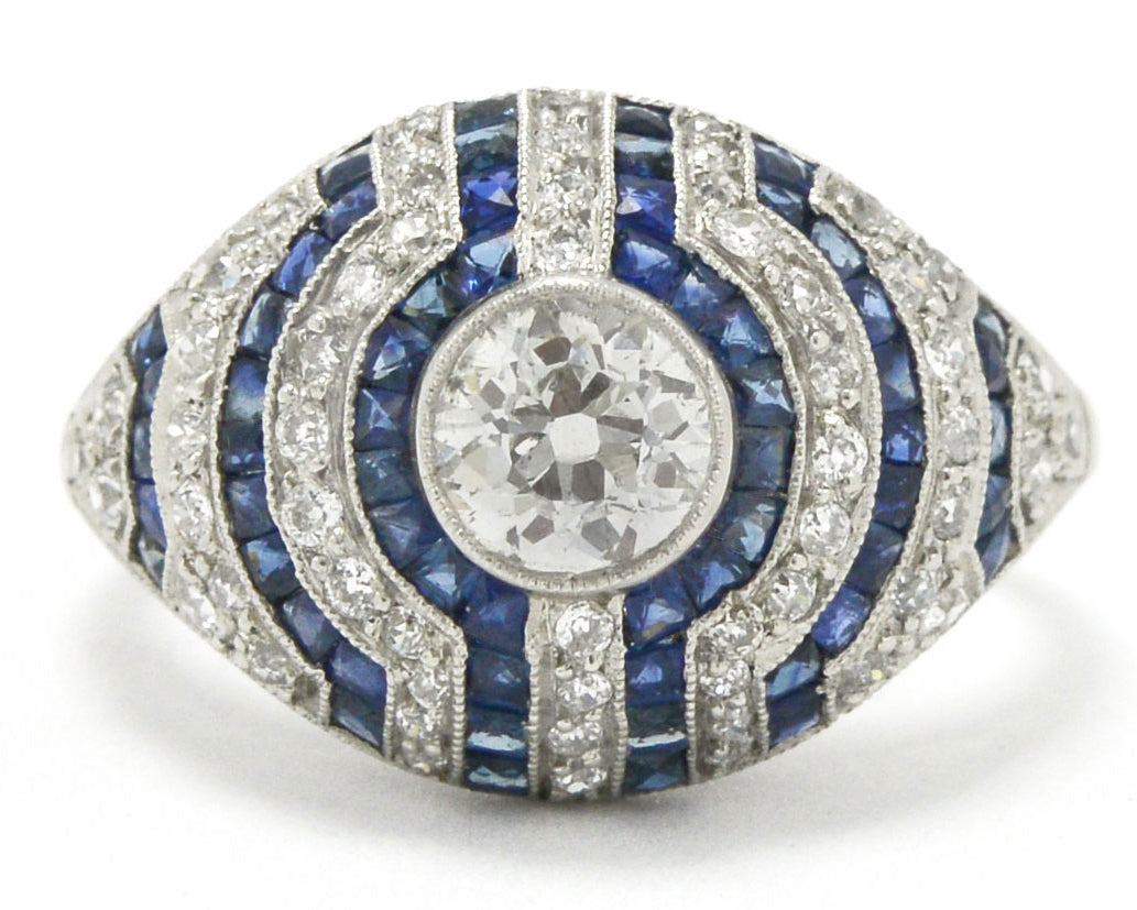 A stripe pattern diamond and blue sapphires engagement ring.