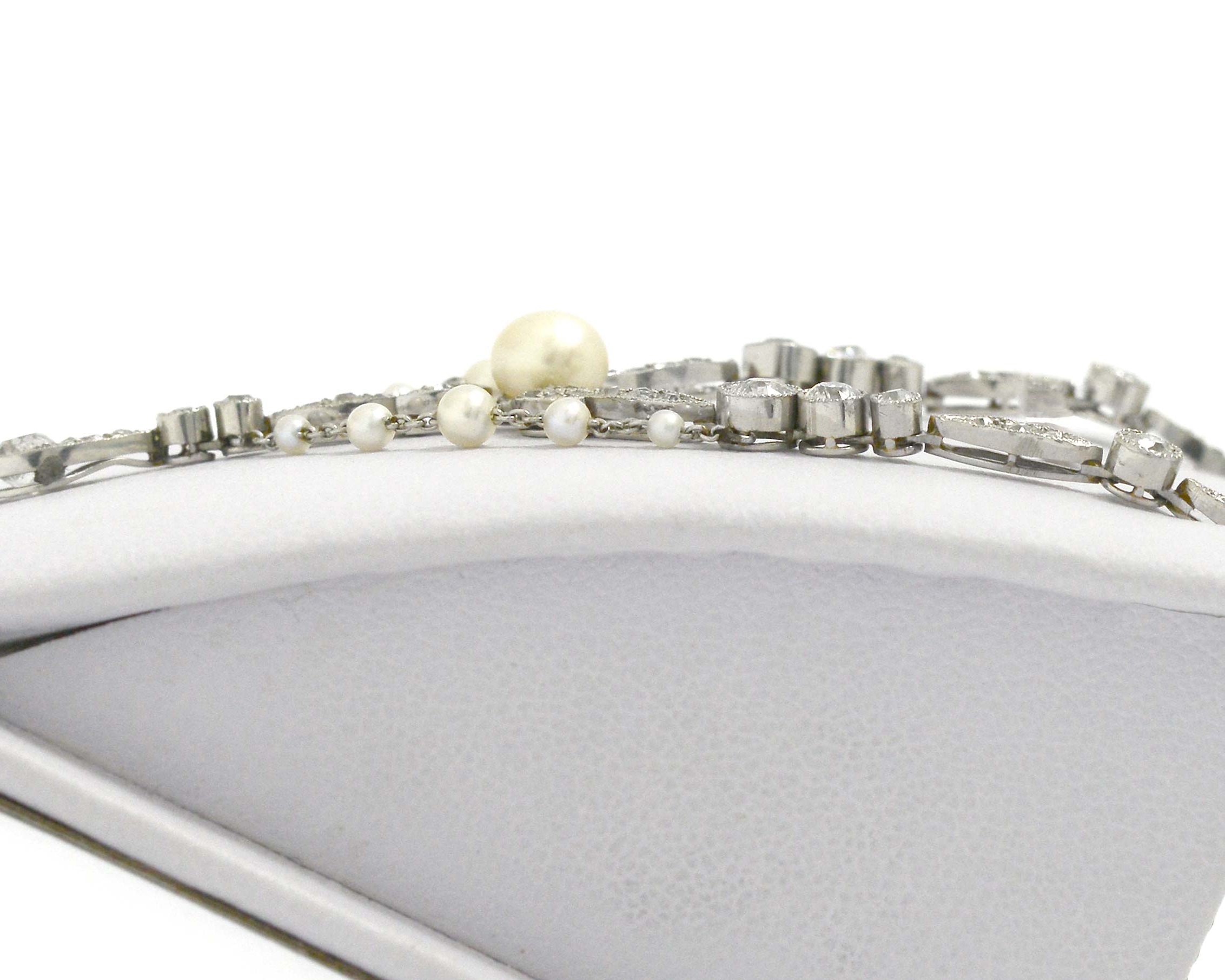 Pearls and diamonds line this filigree platinum Art Nouveau negligee necklace.