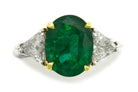 A 4 carat natural emerald and diamond trinity engagemement ring.