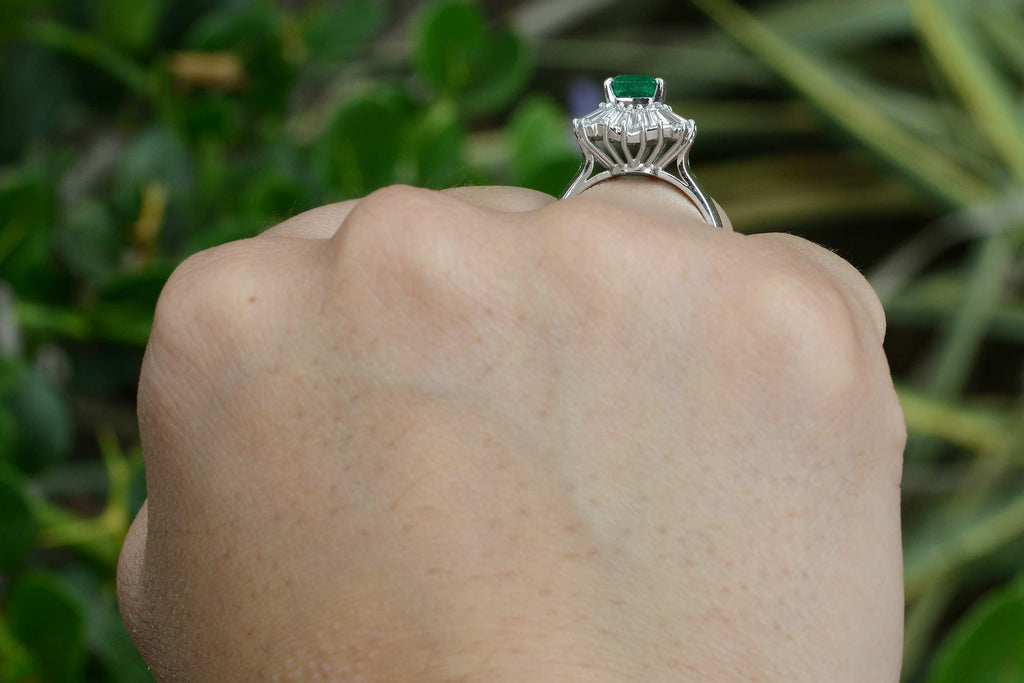 A mid century emerald ballerina ring, accented by a wavy design of diamonds.