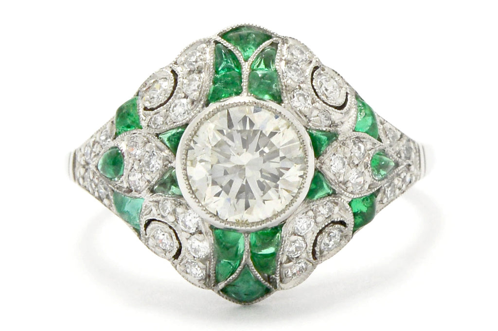 A French Art Deco diamonds and emeralds platinum ring.