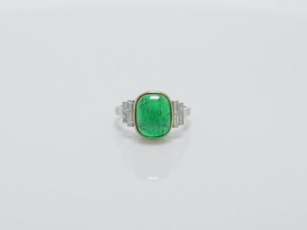 Beautiful scroll filigree supports the underside of this big Colombian emerald ring.
