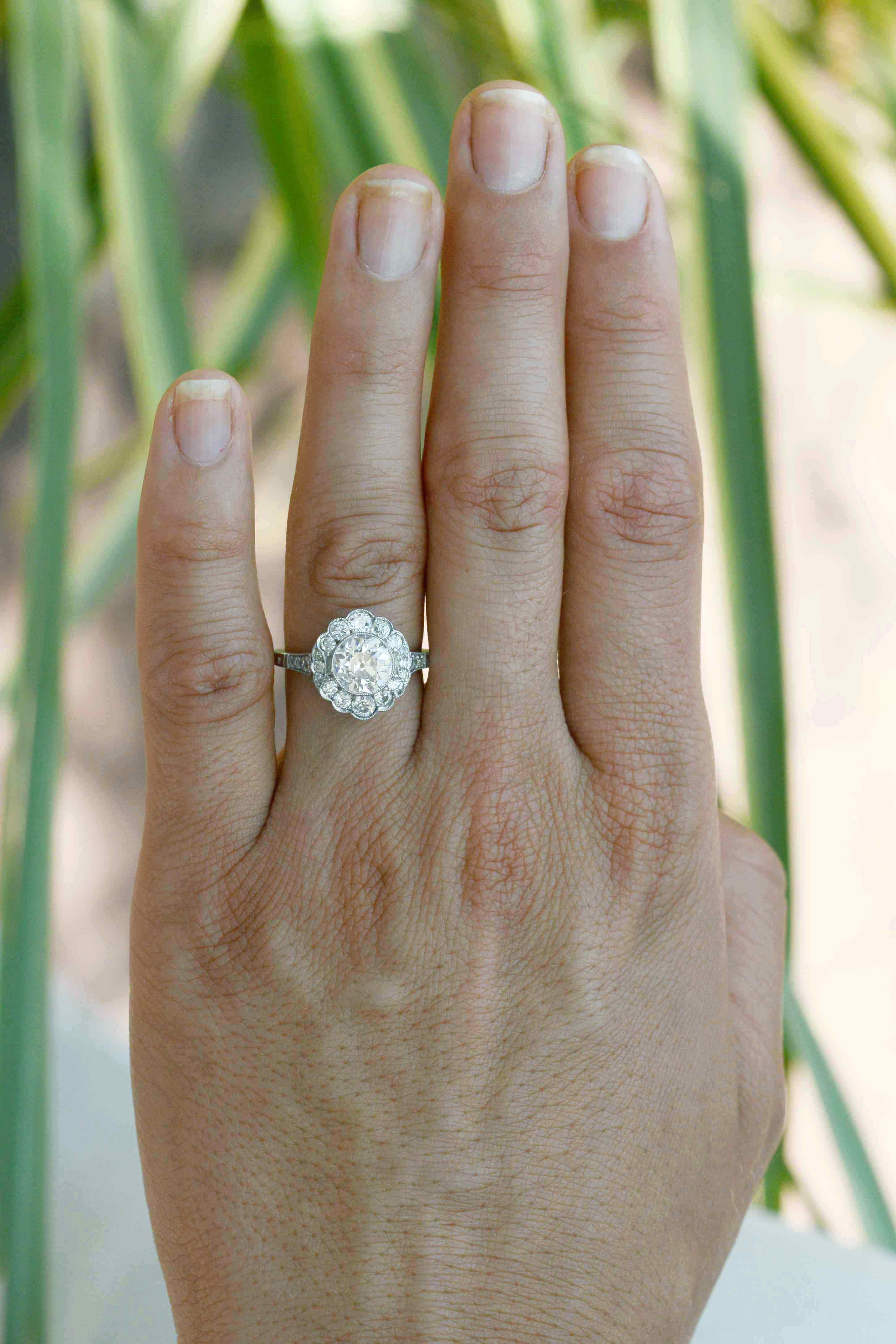 A flower shape diamonds halo engagement ring.