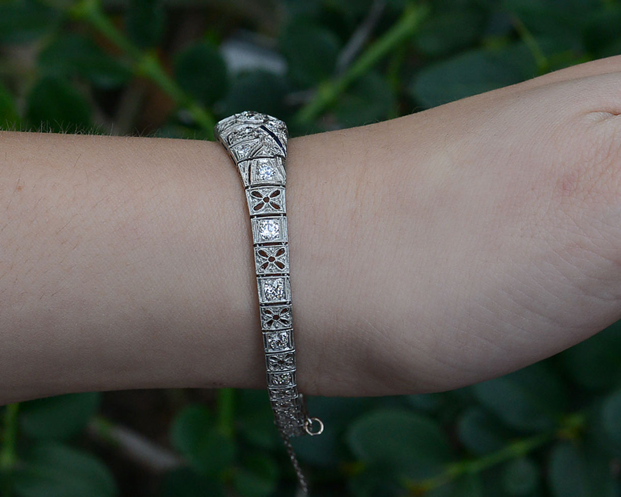 Floral filigree accents are on the sides of this Art Deco diamonds bracelet.