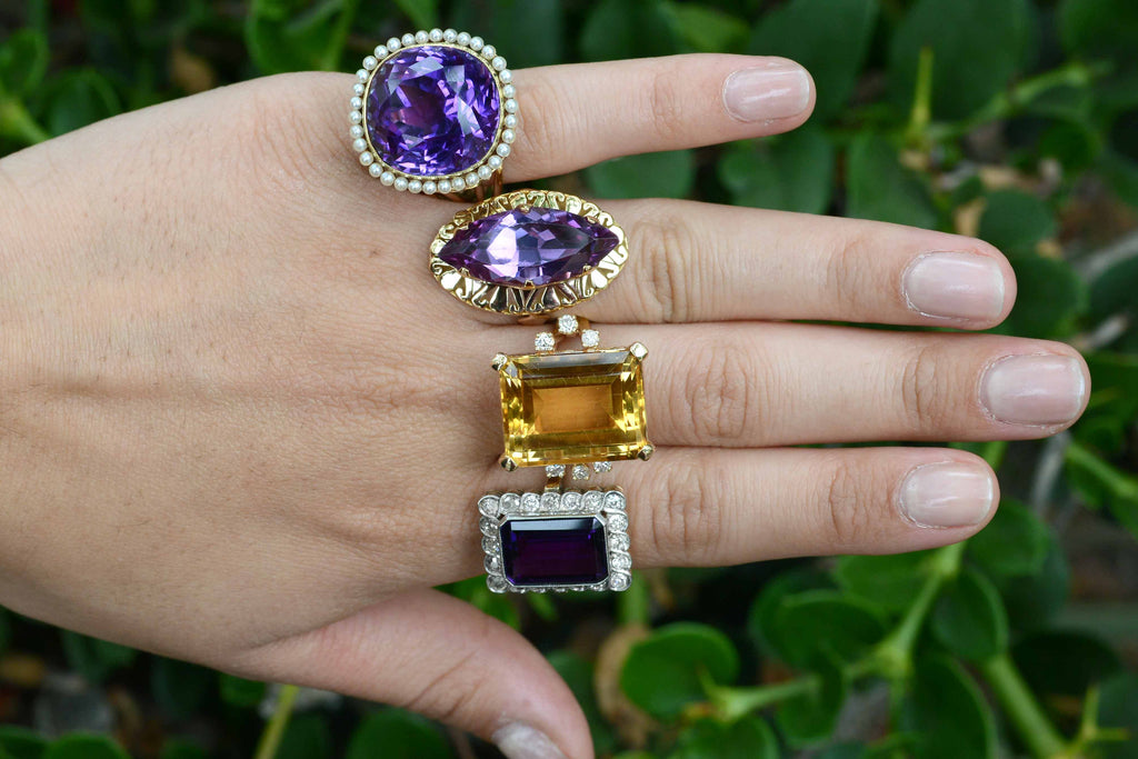 A collection of unique amethyst gold statement rings.