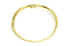 A modern gold snake bracelet design with diamonds and green tsavorite gem eyes.