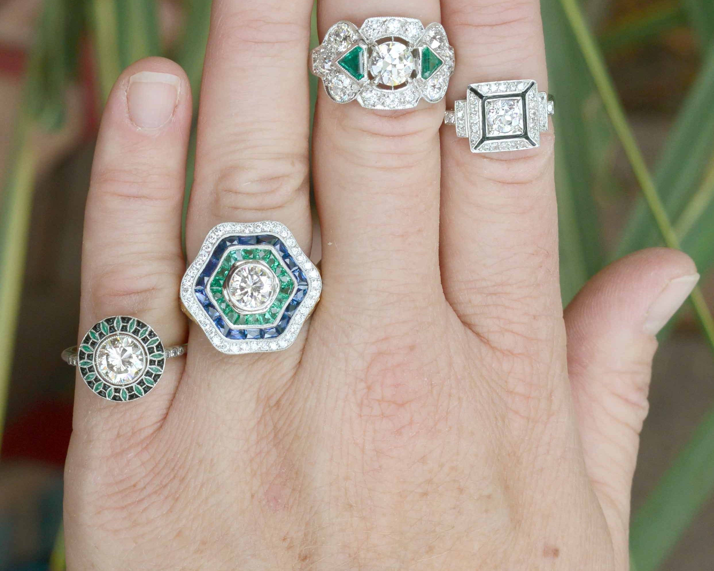 A collection of unique diamond and emerald platinum statement rings.