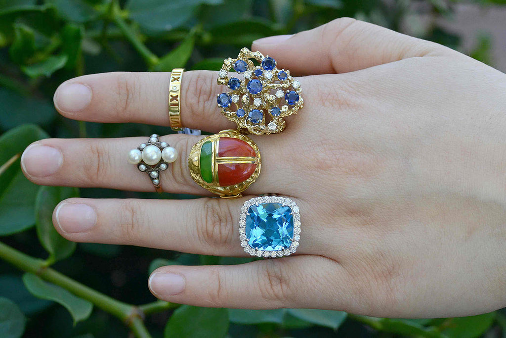 A collection of large, unique gemstone cocktail rings.
