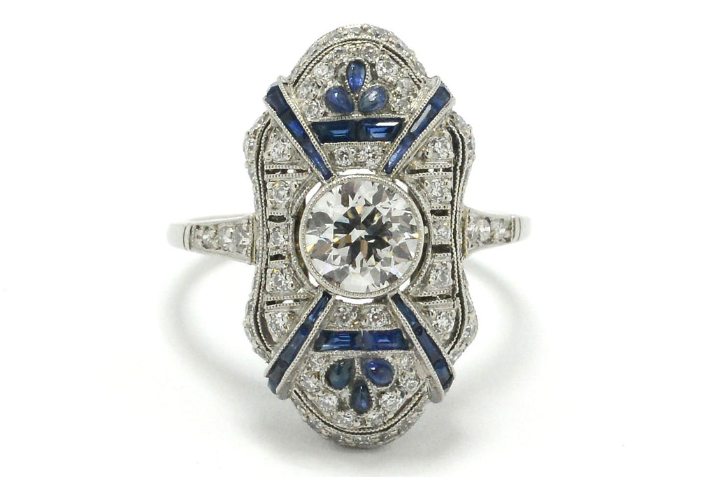 A geometric diamonds and sapphires platinum engagement ring.