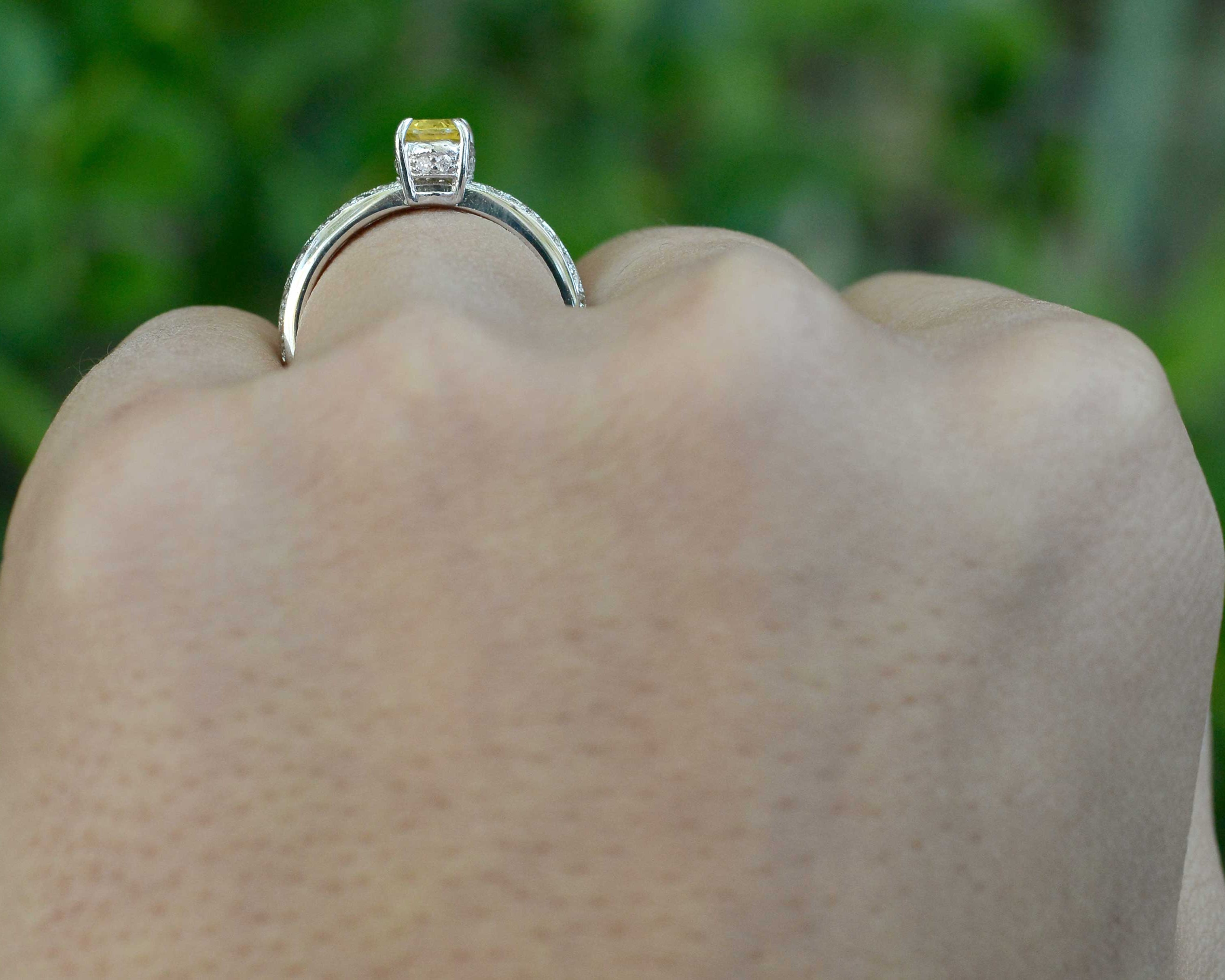 Yellow sapphire 18k white gold engagement ring with a crown setting.