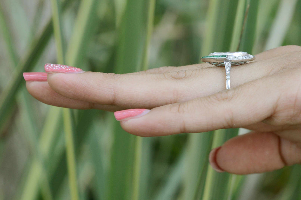 A unique diamond and emerald platinum engagement ring.