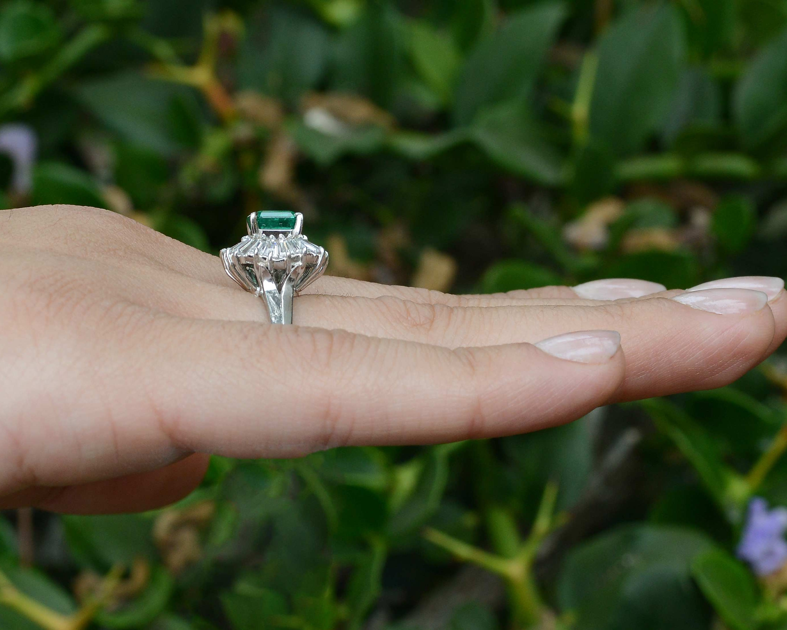 A tall, platinum emerald & diamond mid-century statement ring design.