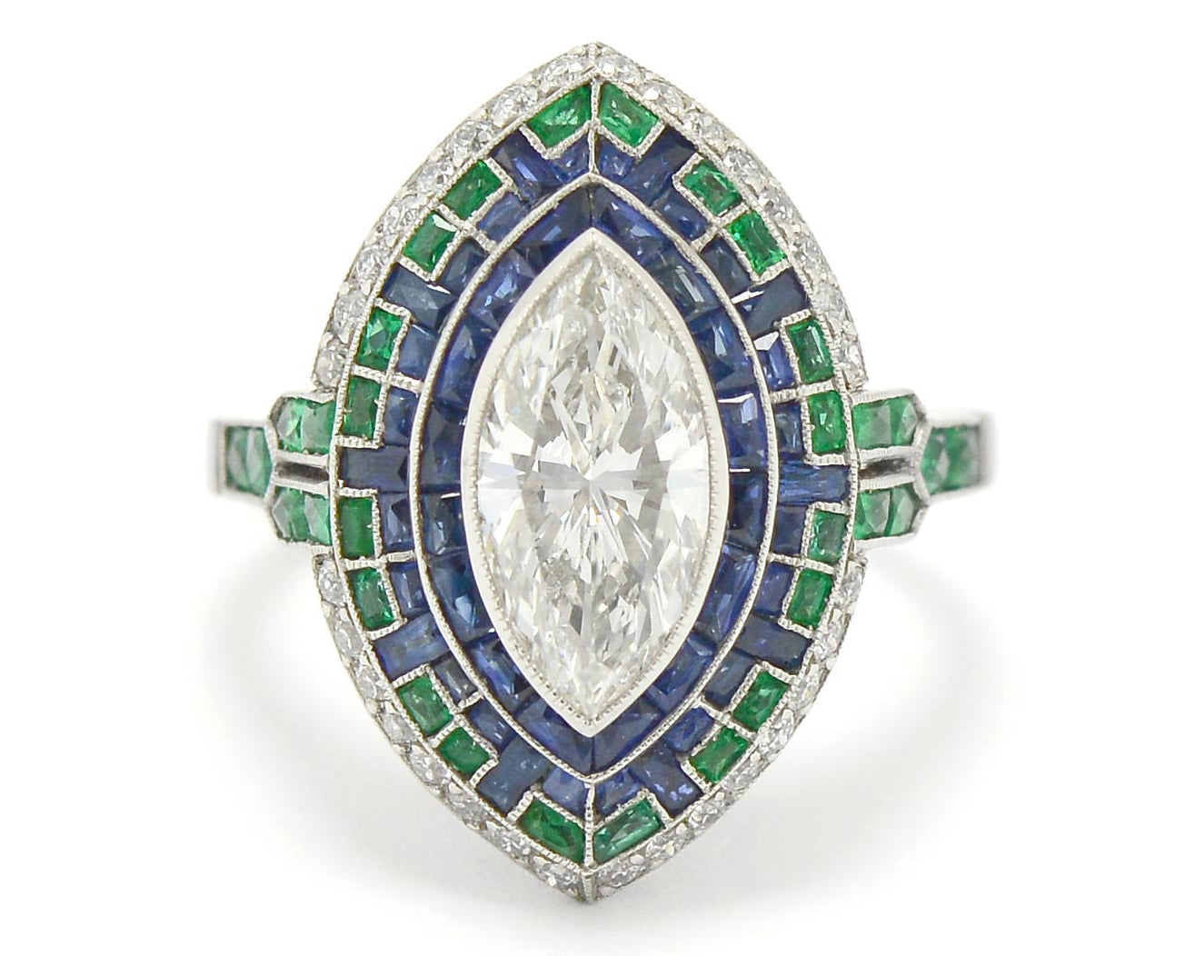 A 4 carat marquise cut diamond in a sapphire and emerald Art Deco mosaic engagement ring.