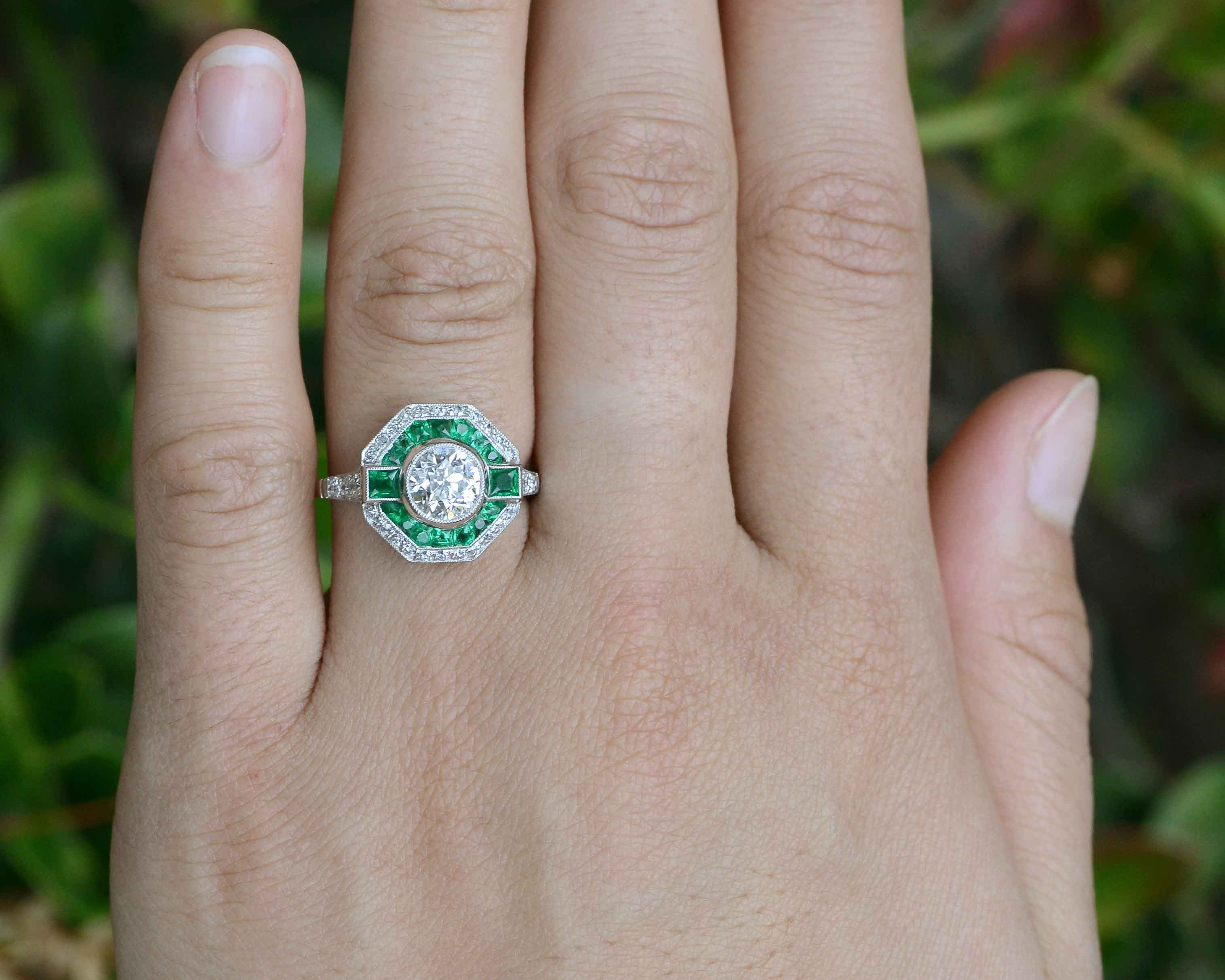 An octagon shape diamond wedding ring with an emerald halo.
