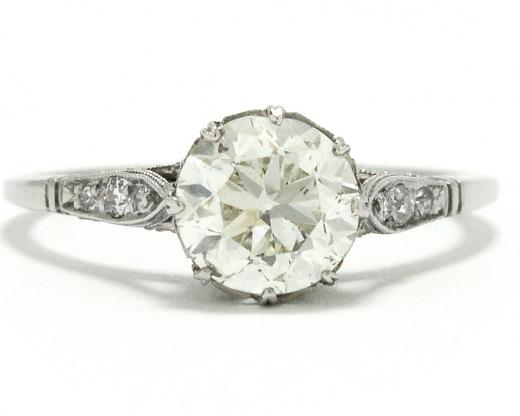 The center diamond in this Edwardian style solitaire ring is over one carat.