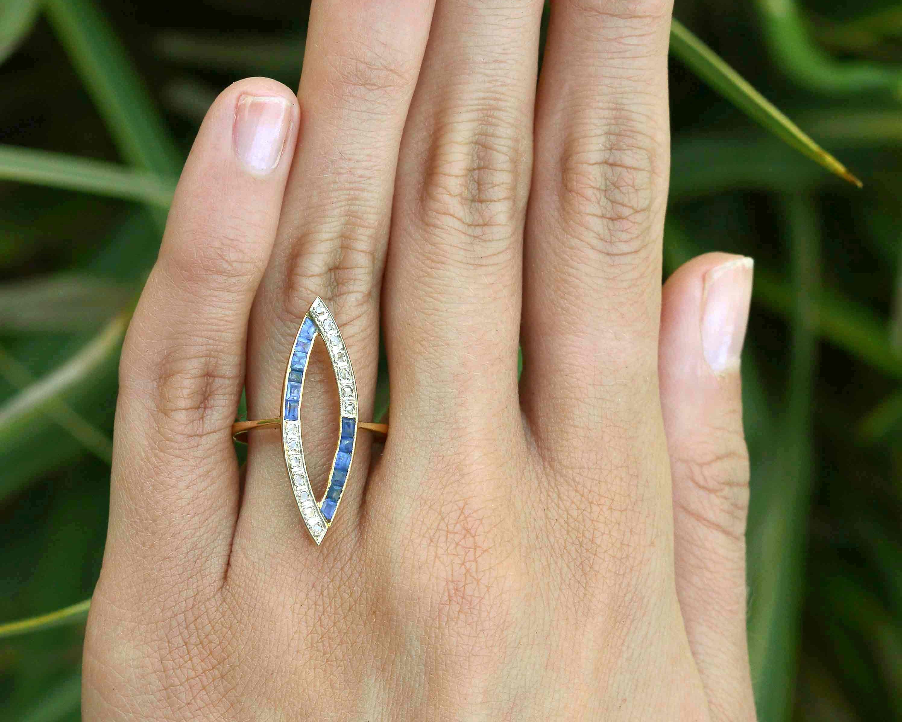 Rose cut diamonds and French blue sapphires line this open work navette ring. 