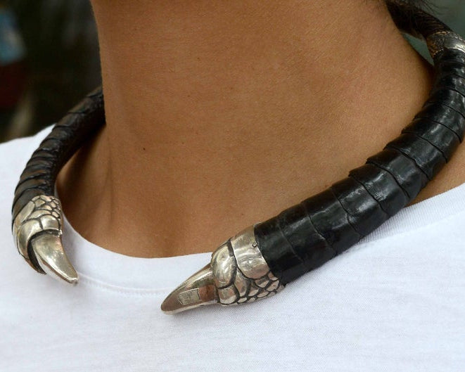 An exotic BDSM silver claw and black leather necklace.