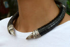 An exotic BDSM silver claw and black leather necklace.