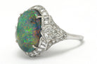 Dome black opal cocktail ring with kite and baguette diamonds.