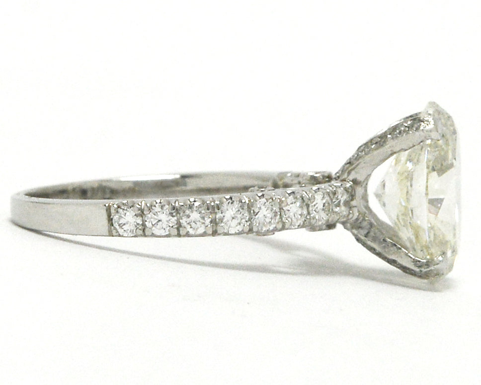 Diamonds are on the straight band of this solitaire wedding ring.