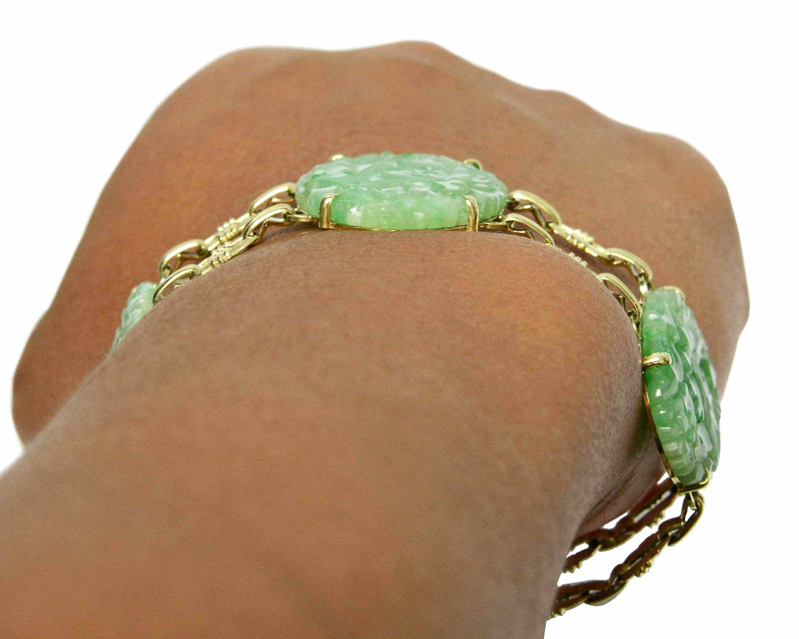 An antique, low profile oval jade and gold link bracelet.
