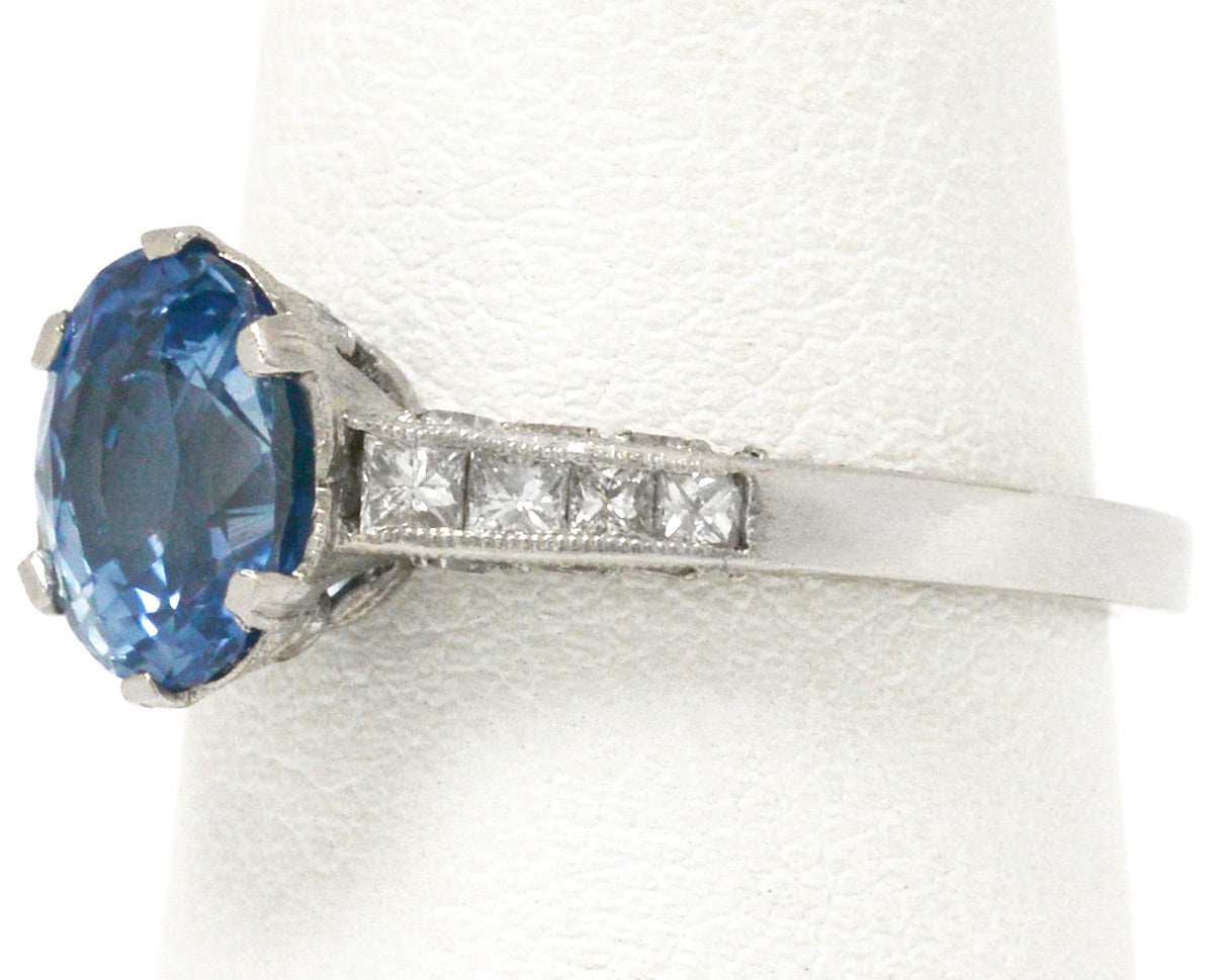 8 diamonds support the ceylon blue sapphire in this platinum vintage engagement ring.