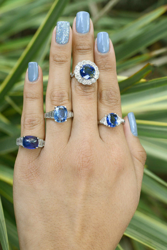 A collection of large blue sapphire and diamond engagement rings.