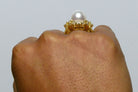 A round natural pearl gold dome cocktail ring.