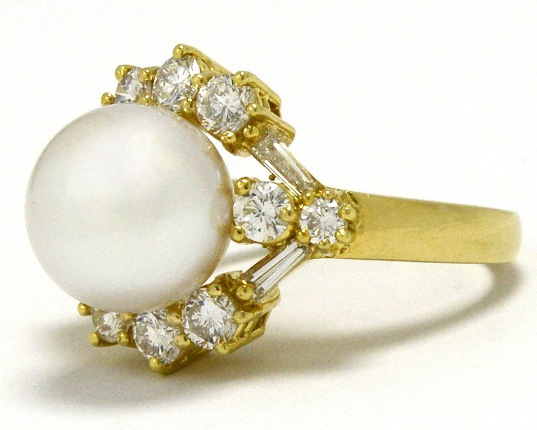 A modern natural pearl dome ring lined with diamonds around.