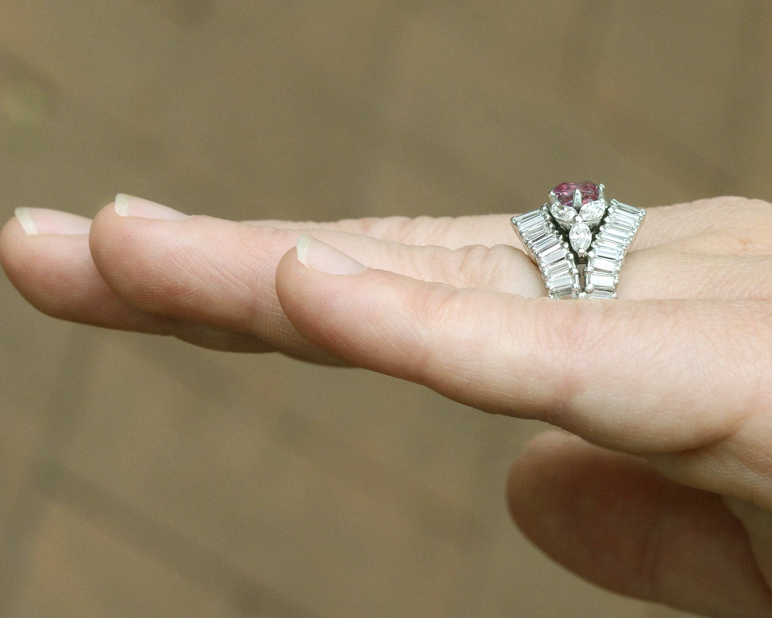 A floral, pink sapphire platinum vintage cocktail ring.
