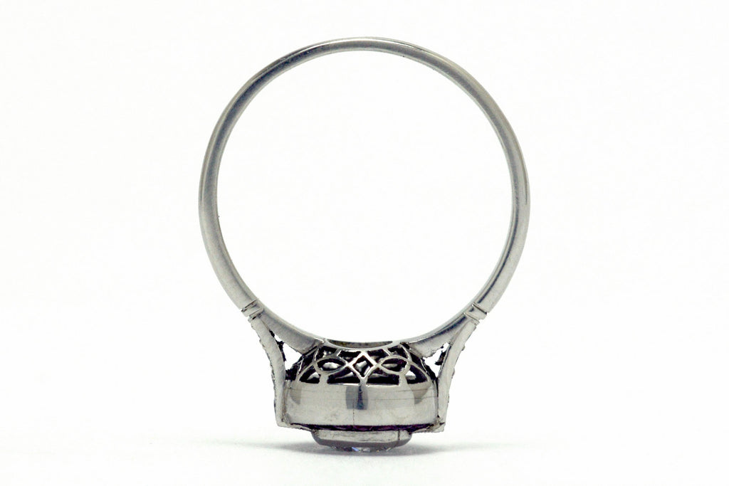A platinum bezel diamond engagement ring design.