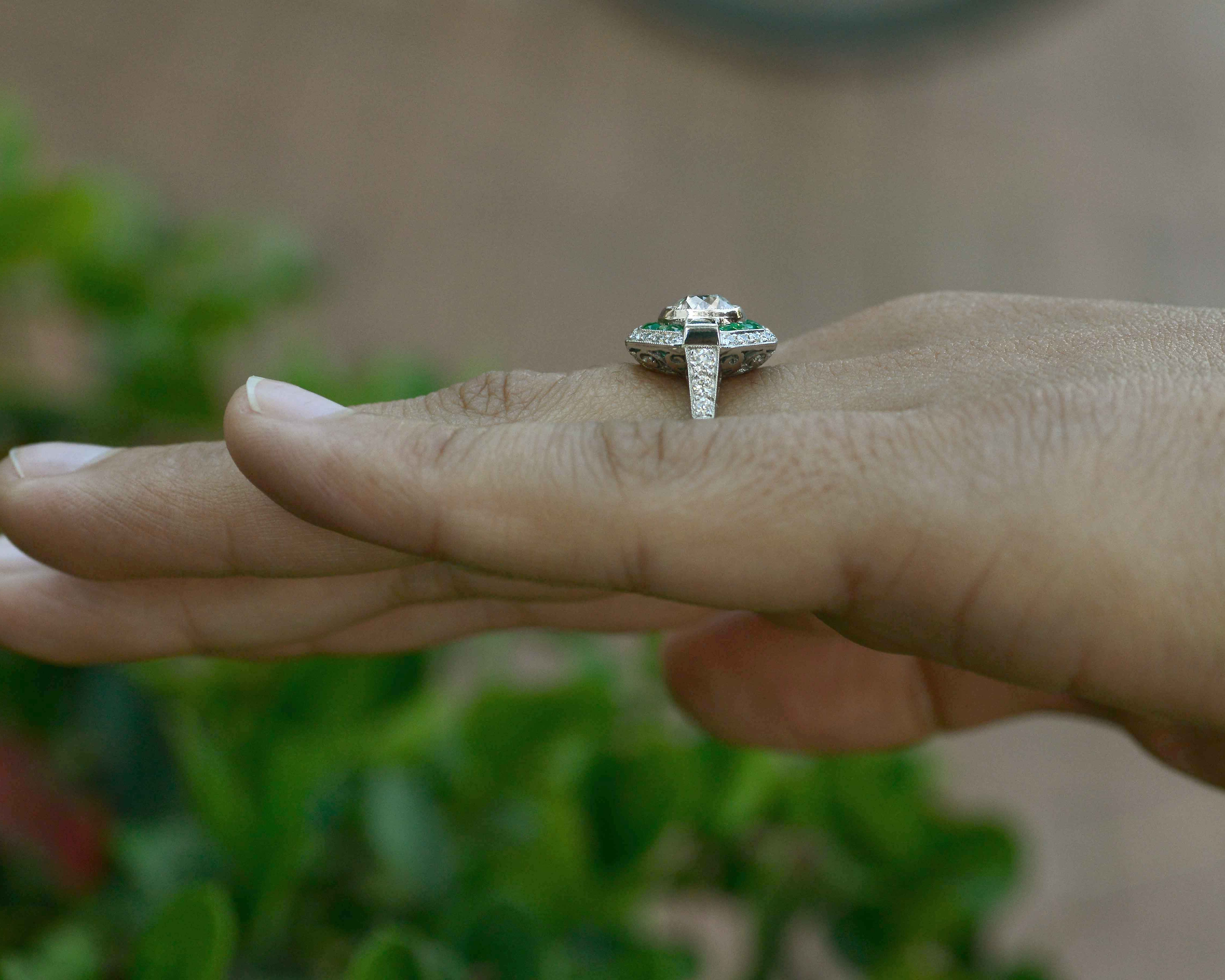 A unique geometric diamond emerald halo pattern wedding ring.