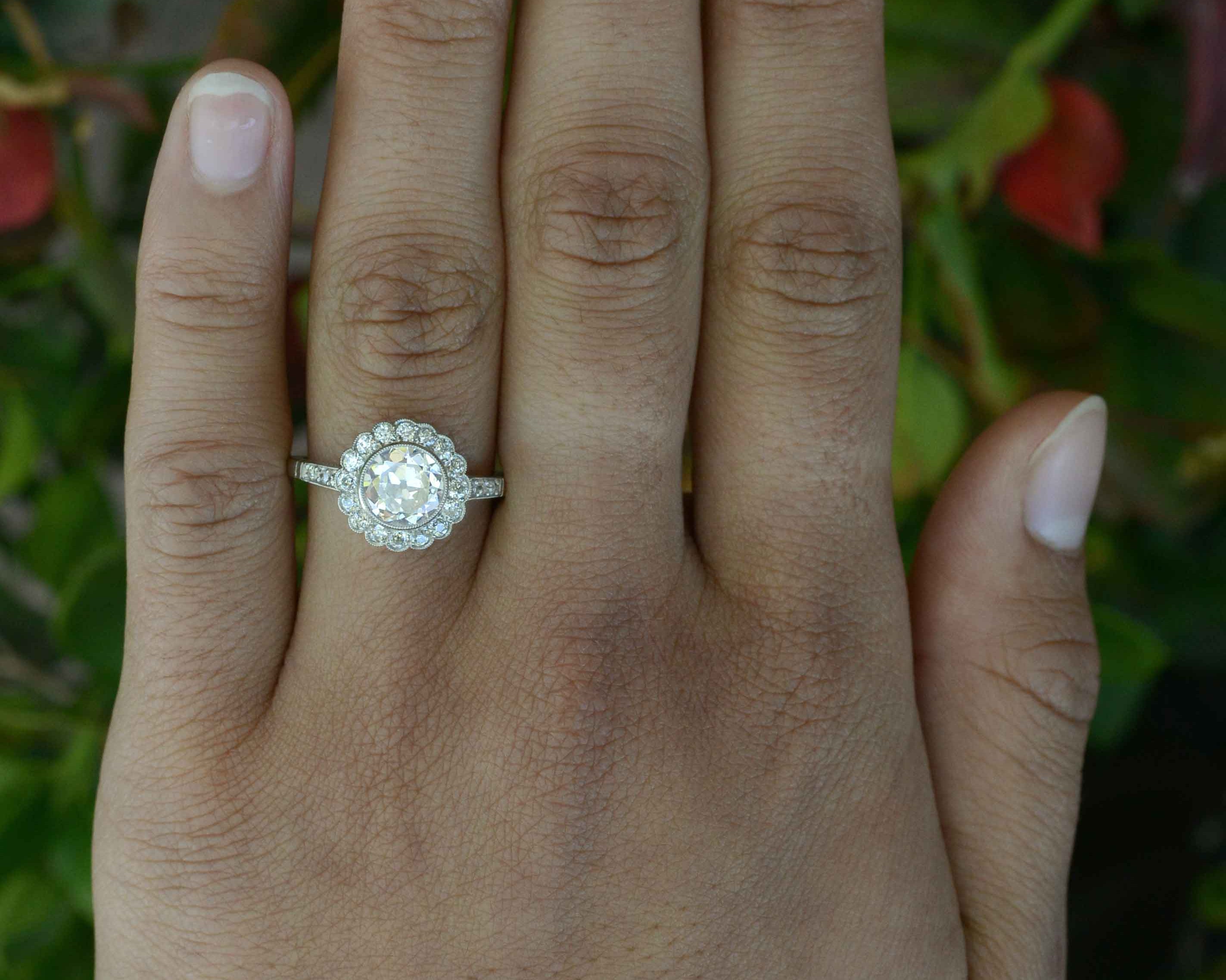 Old European diamond flower petal cluster engagement ring.