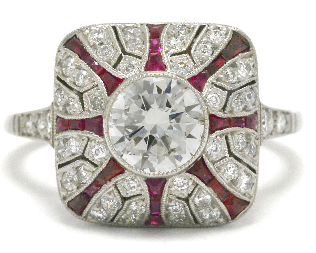 A diamond and ruby starburst platinum Art Deco engagement ring.