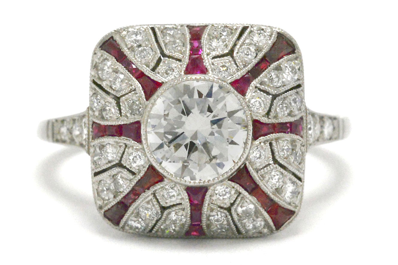 A diamond and ruby starburst platinum Art Deco engagement ring.