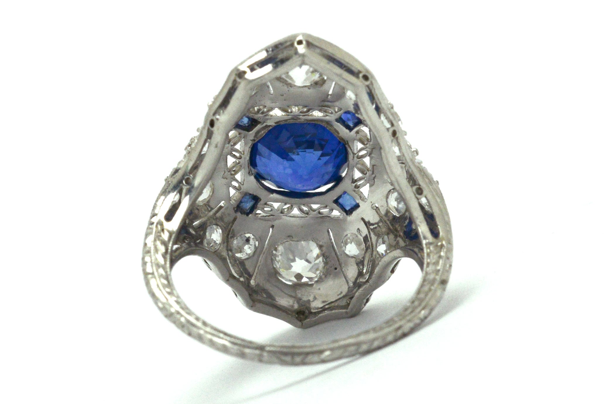 This long platinum shield cocktail ring holds a 2 carat round sapphire and diamonds.