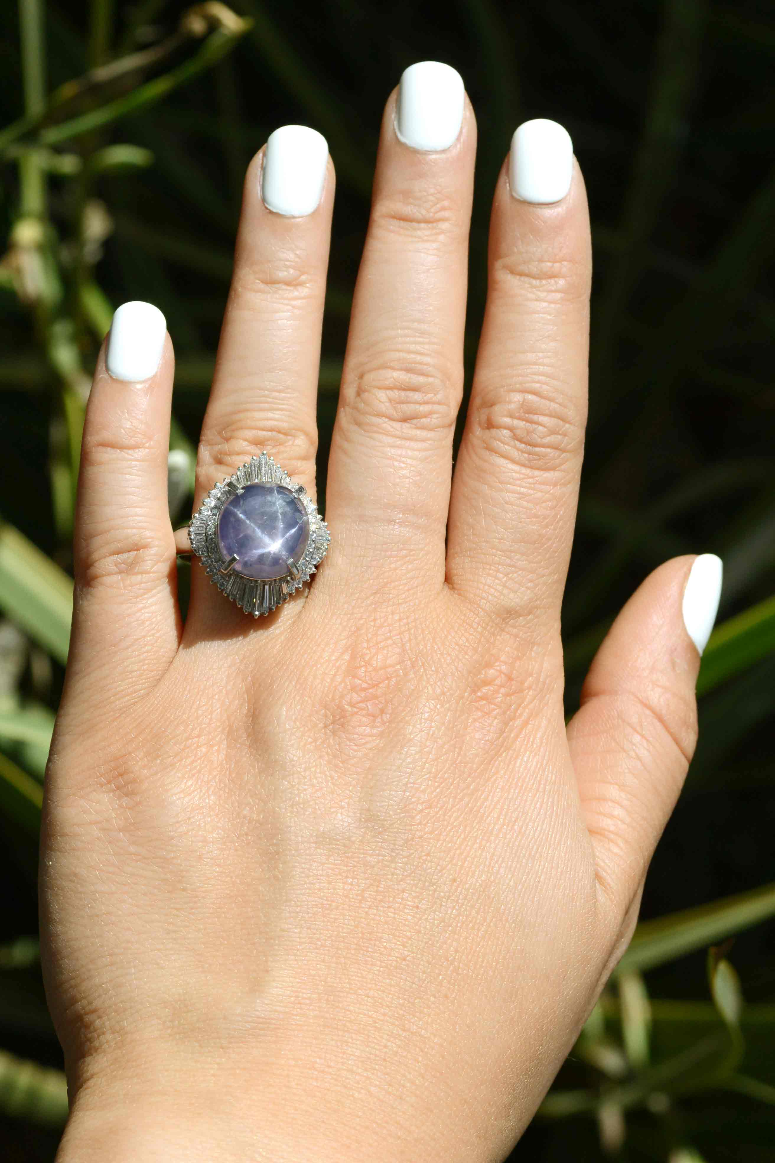 A 6 point star purple sapphire and diamond halo ballerina ring.