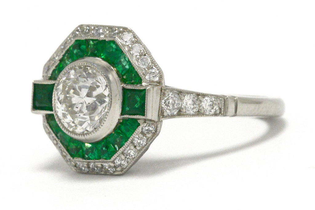 A transitional round brilliant diamond emerald halo octagon engaggement ring.