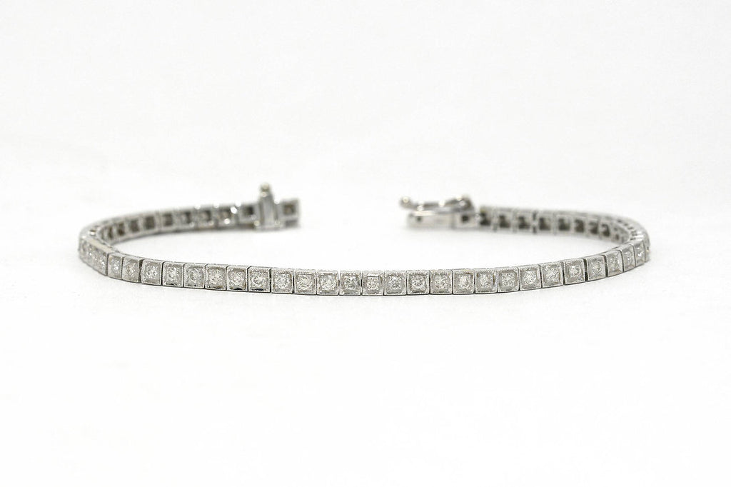 Two carats of straight line set diamonds in a 1940s white gold tennis bracelet.