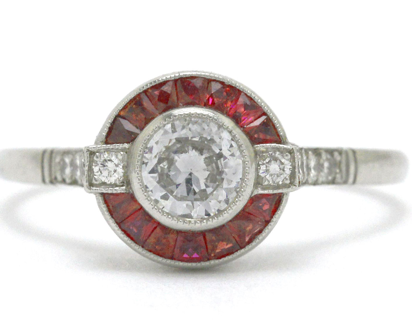 An Art Deco diamond ruby arch, halo engagement ring.