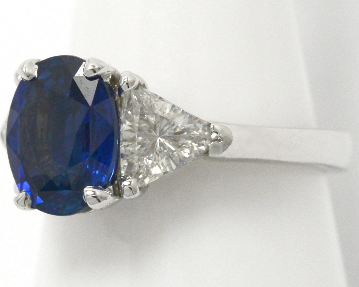 1.50 carats of trillion cut diamonds support this large ceylon sapphire engagement ring.