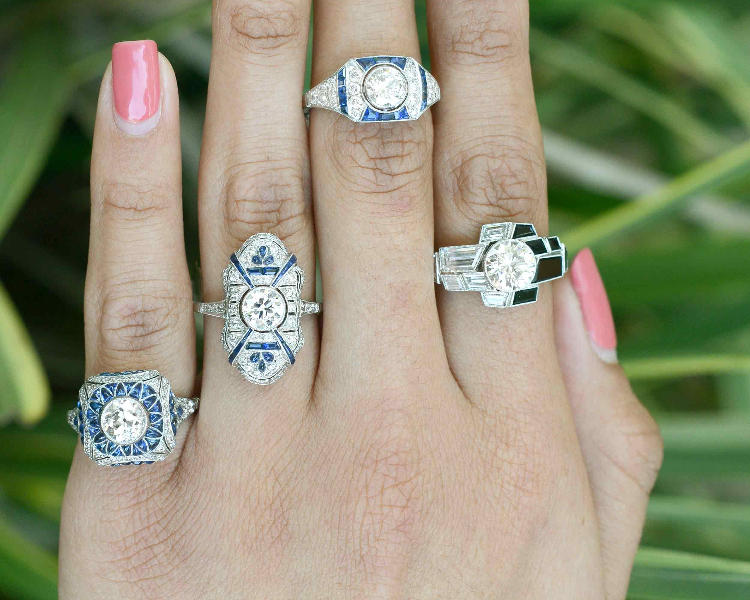A collection of diamond and sapphire Art Deco wedding rings.